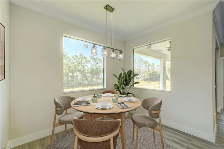 Virtual Stage - Living room featuring light wood-style floors, a raised ceiling, a ceiling fan, crown molding, and recessed lighting