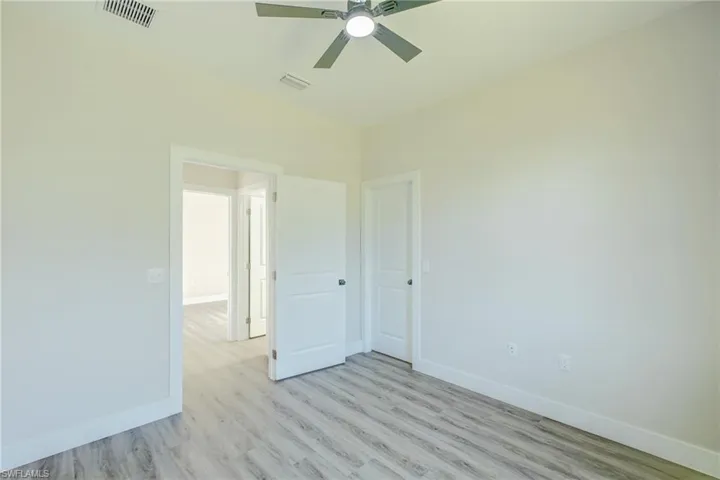 Unfurnished bedroom with a ceiling fan and light wood finished floors