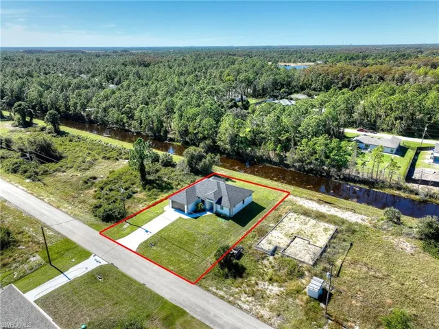Aerial view of property's location featuring a nearby body of water and property boundaries highlighted