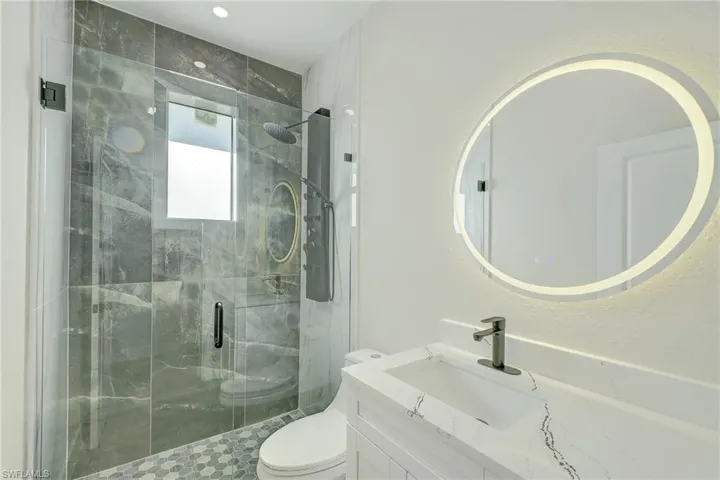 Full bathroom featuring vanity and a shower stall
