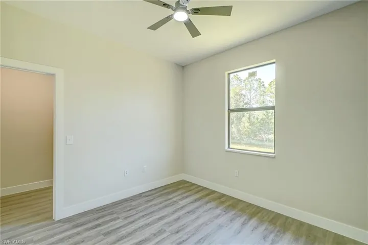 Unfurnished room with light wood finished floors and a ceiling fan