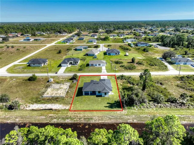 Aerial view of residential area with property boundaries highlighted