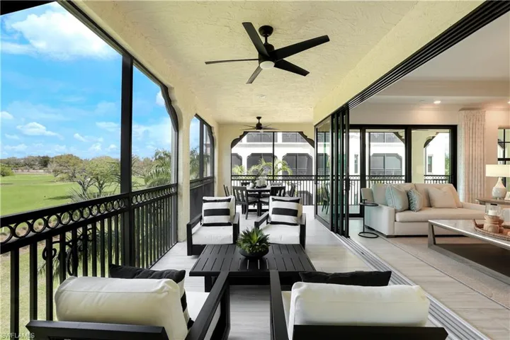 Sunroom featuring outdoor seating, a ceiling fan, and golf course view