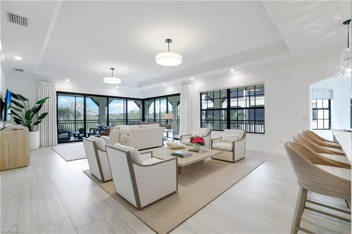 Living room with a raised ceiling and baseboards