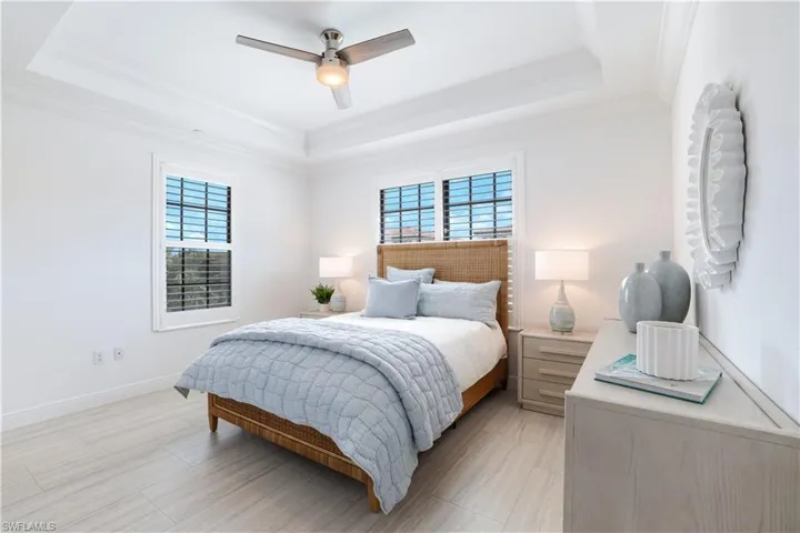 Bedroom featuring a ceiling fan and crown molding