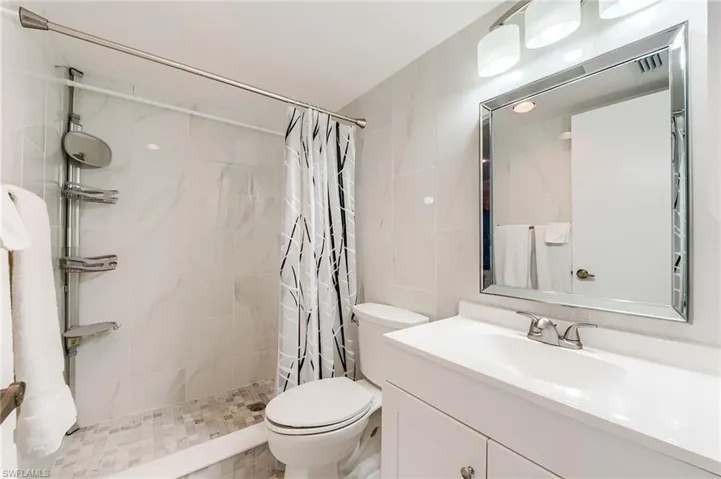 Master BathroomBrand new cabinetry, countertops, tile, Kohler toilet, fixtures and lighting