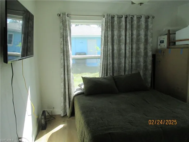 Secondary bedroom with wood finished floors
