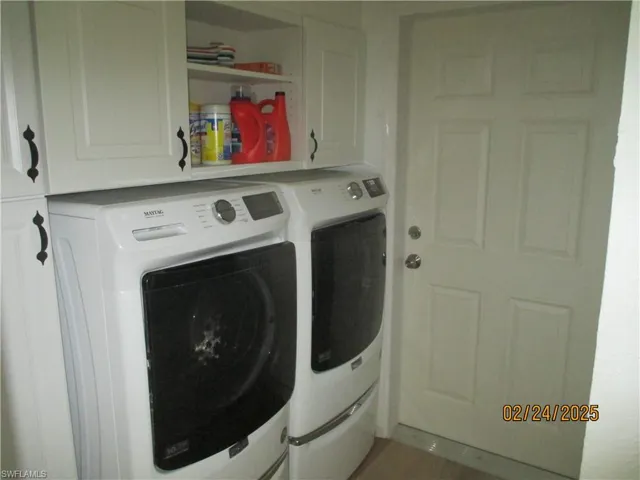 Laundry room with cabinet space for washing machine and clothes dryer