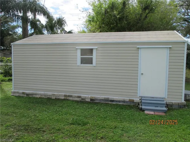 View of outbuilding with entry steps