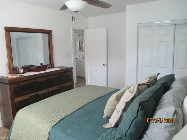 Primary bedroom with closet, and a ceiling fan