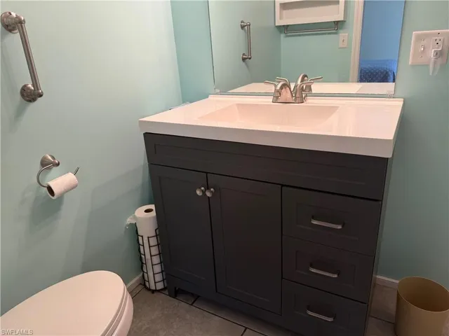 Bathroom with tile patterned flooring, vanity, and toilet
