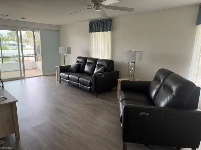 Living room with ceiling fan and wood-type flooring