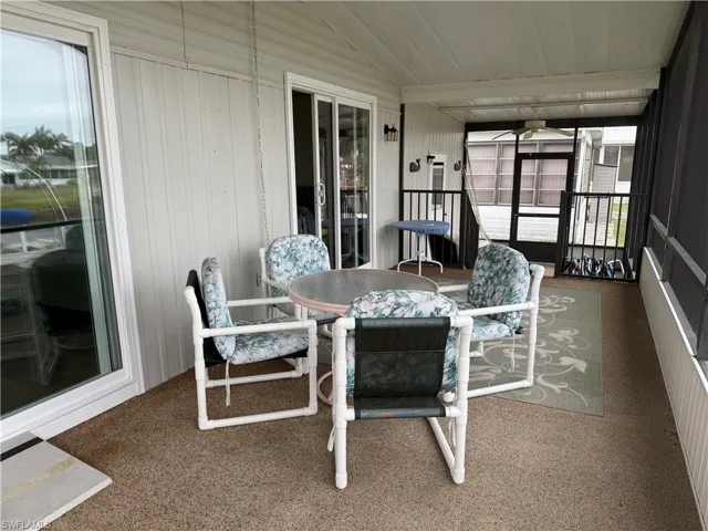 Sunroom / solarium featuring a healthy amount of sunlight and lofted ceiling
