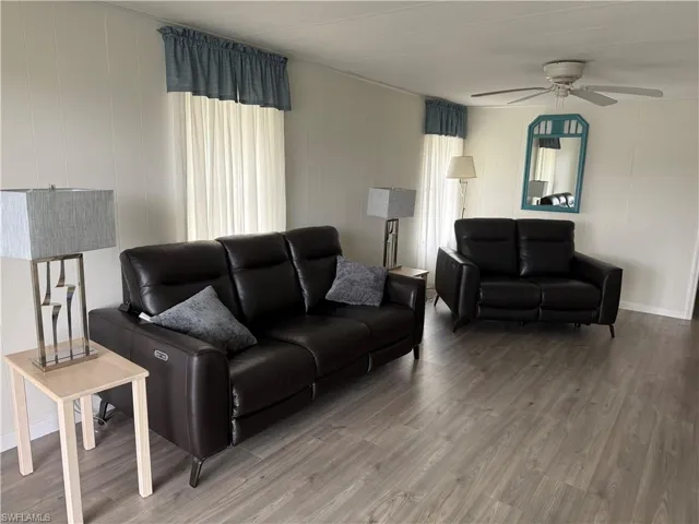 Living room featuring ceiling fan and wood-type flooring