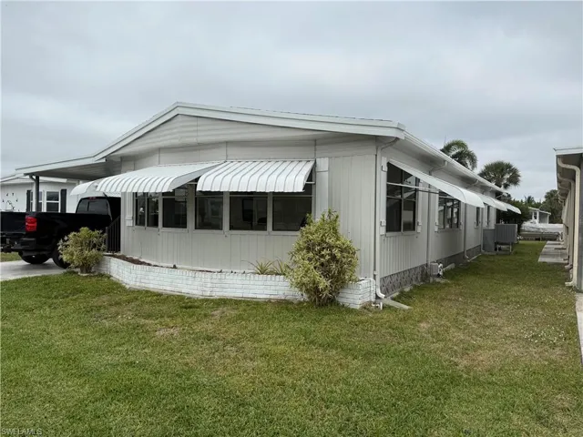 View of property exterior with a lawn
