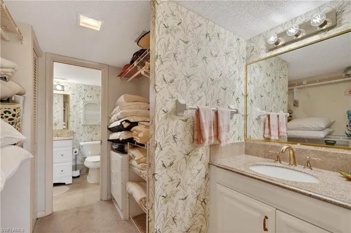 Master Bathroom and walk through closet with vanity