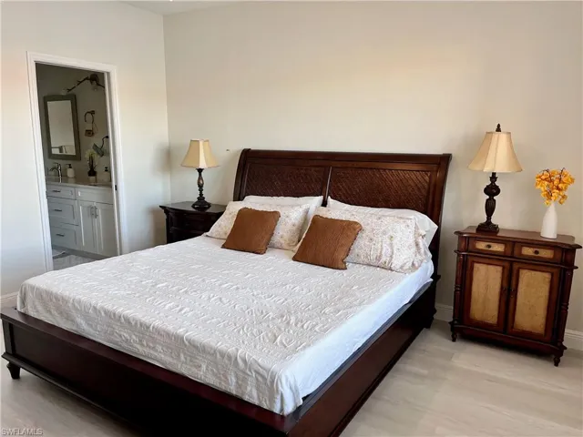 Bedroom featuring connected bathroom and light wood-style floors