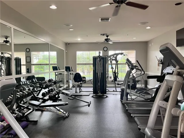 Exercise room with a ceiling fan and recessed lighting