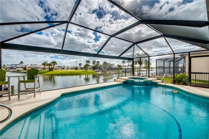 It doesn't get much better than this! Picture window cage framing opens up the incredible water views across the intersecting canal and Alhambra Lake