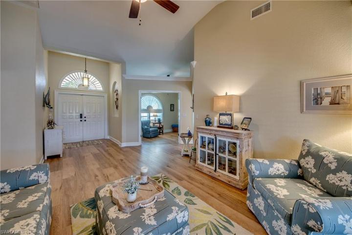 Double door entry with half moon transom window allows for ample natural light