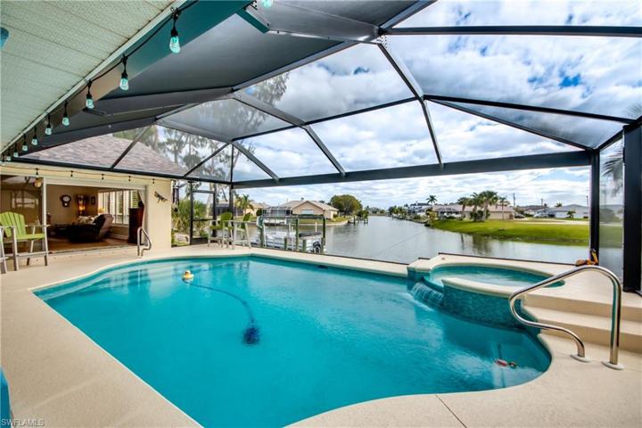 Newly re-surfaced, new water tiles and gentle waterfall flow from the hot tub to the pool.