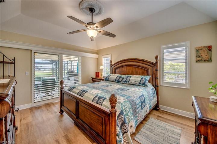 Master bedroom with sliders out to the lanai. Custom plantation shutters!
