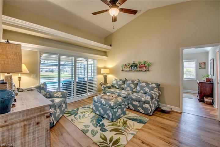 Your greeted by this beautiful living room as you enter the home. Sliders over-looking pool and canal. Custom plantation shutters.