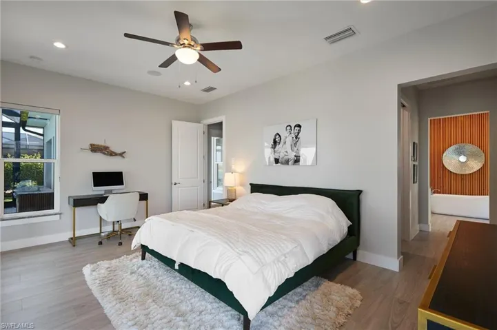 Bedroom with recessed lighting, visible vents, baseboards, and wood finished floors