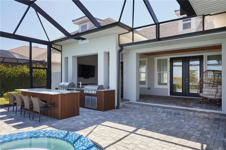 View of patio / terrace featuring outdoor wet bar, area for grilling, an outdoor kitchen, and french doors
