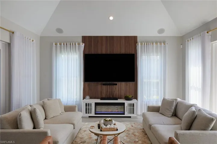 Living area featuring lofted ceiling