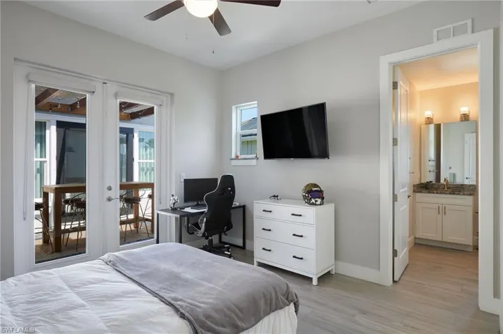 Bedroom featuring visible vents, baseboards, access to exterior, light wood-style floors, and french doors