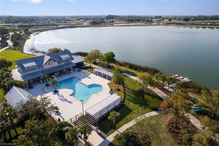 Birds eye view of property with a water view
