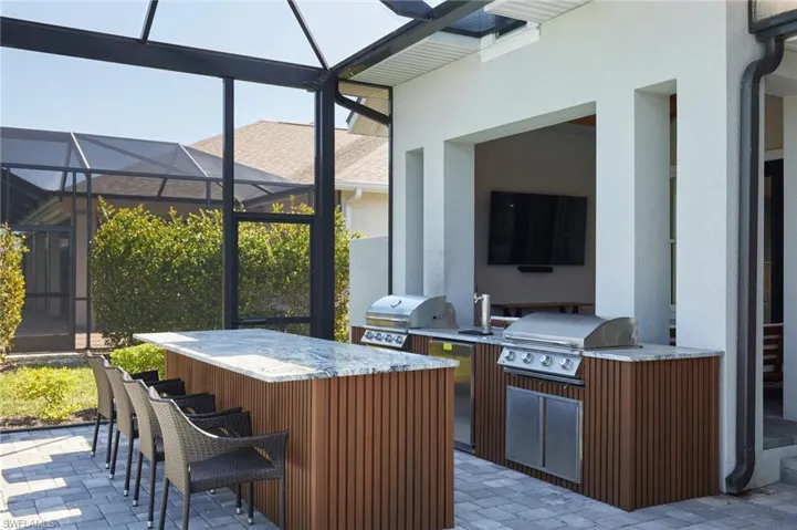 Sunroom featuring outdoor wet bar and area for grilling