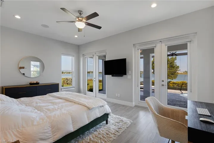 Bedroom with baseboards, light wood-type flooring, recessed lighting, a ceiling fan, and access to outside