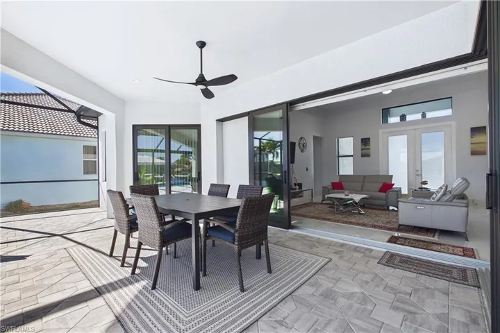 Dining space with french doors, a ceiling fan, and a sunroom