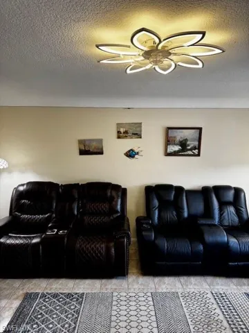 Living area featuring a textured ceiling