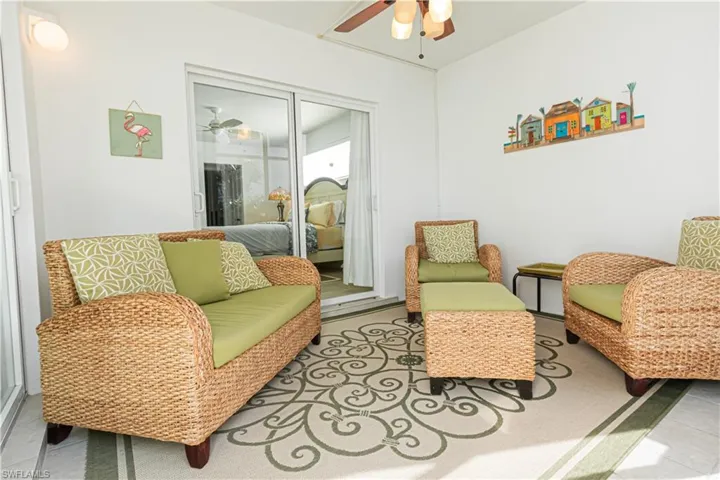 Living area featuring a ceiling fan and light tile patterned floors
