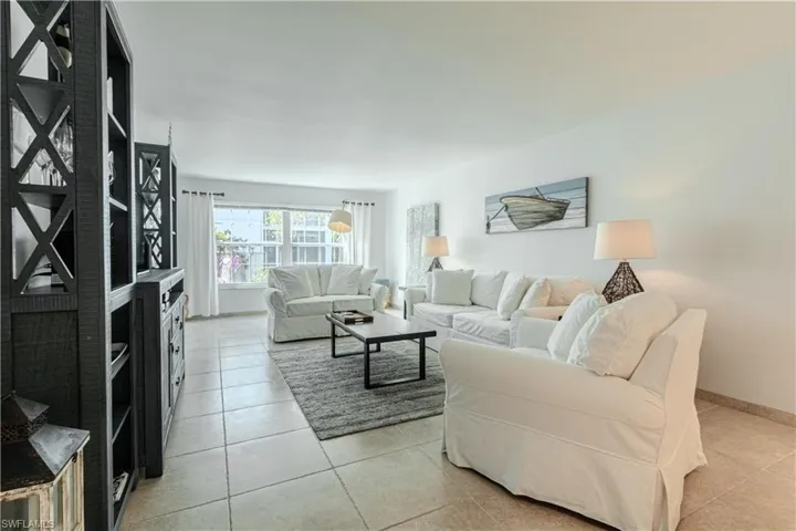 Living room with light tile patterned floors and baseboards