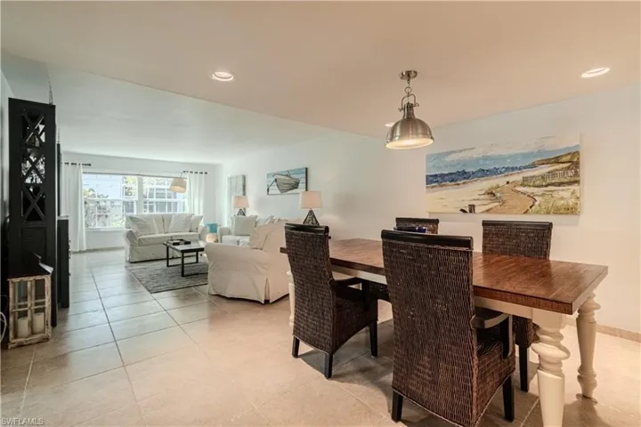 Dining space with recessed lighting and light tile patterned floors