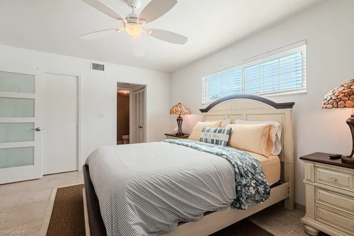 Bedroom featuring light tile patterned flooring and ceiling fan