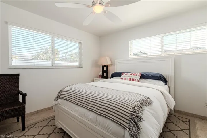 Bedroom featuring multiple windows and ceiling fan