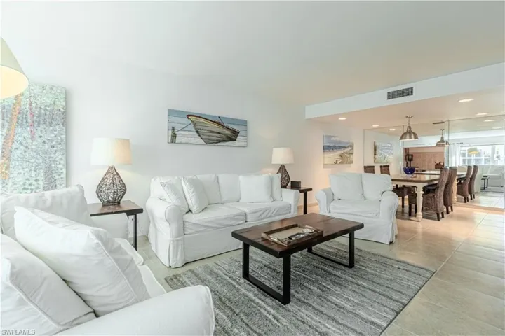 Living area featuring tile patterned flooring and recessed lighting