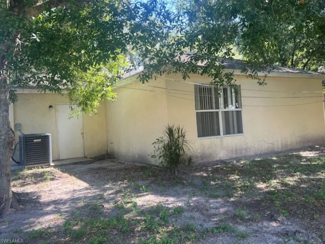 View of side of home featuring central air condition unit