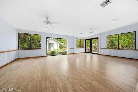 Unfurnished living room featuring light wood finished floors and ceiling fan