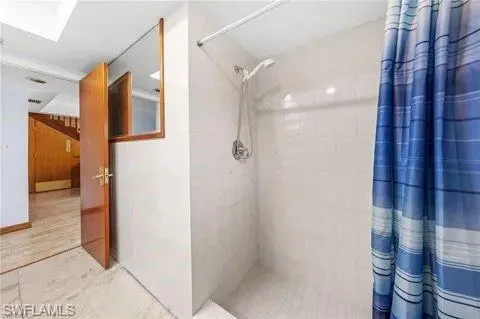 Full bath featuring a shower stall