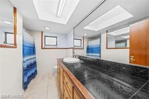Bathroom with a shower stall and vanity