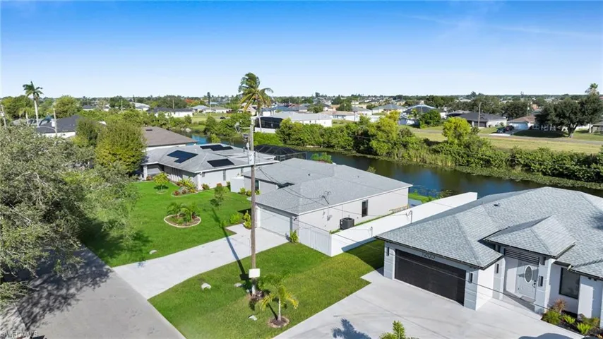 Aerial perspective of suburban area with a nearby body of water