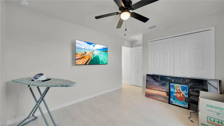 Unfurnished office featuring baseboards and a ceiling fan