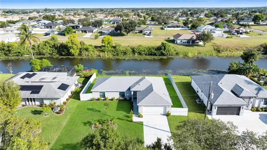 Aerial perspective of suburban area featuring a large body of water