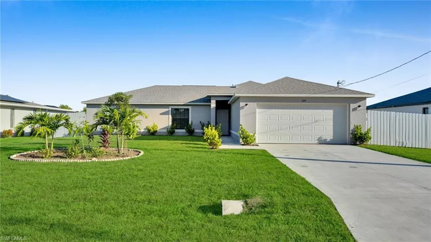 Ranch-style home with concrete driveway, a shingled roof, an attached garage, and stucco siding